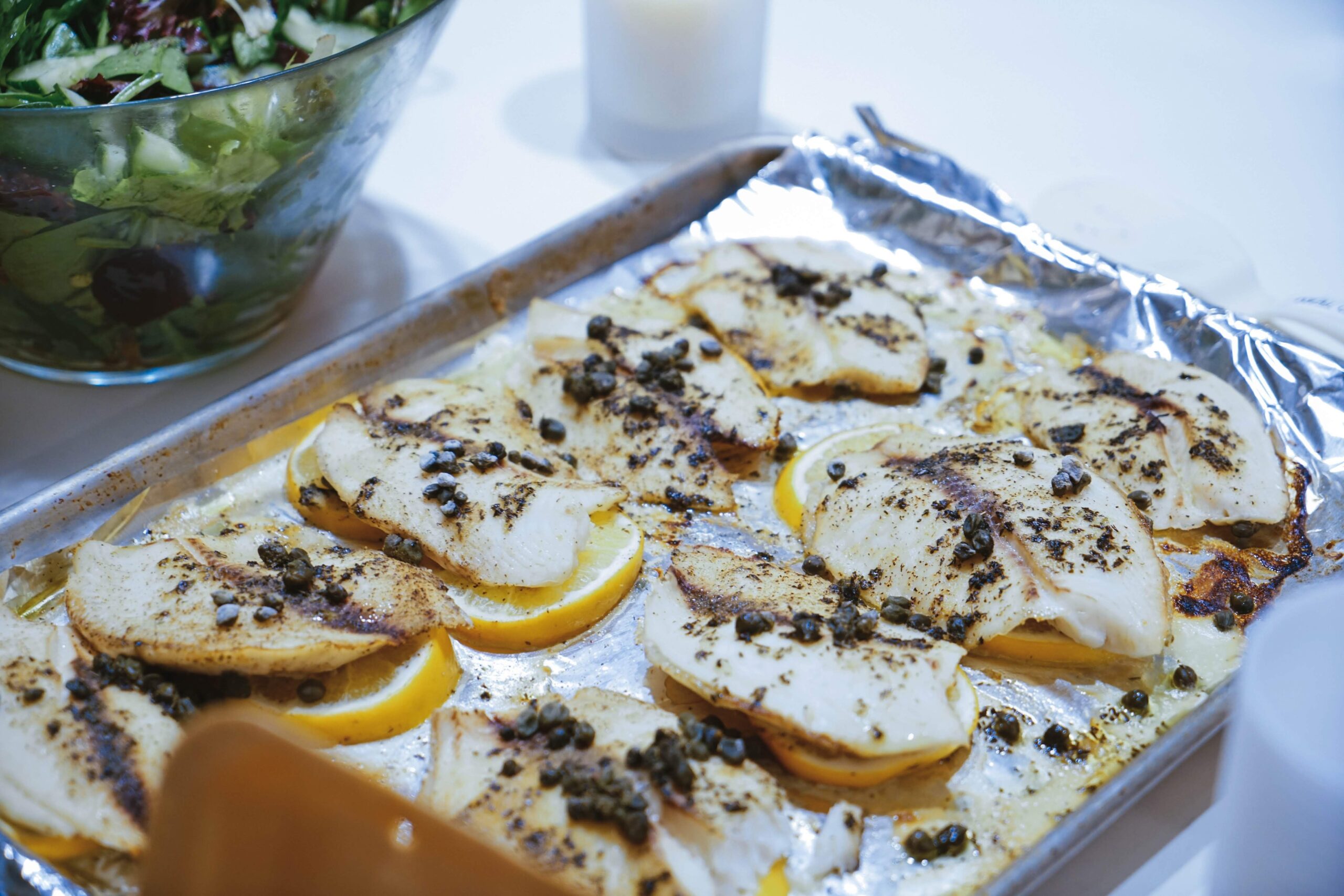 Fish fillets cooking over an open flame