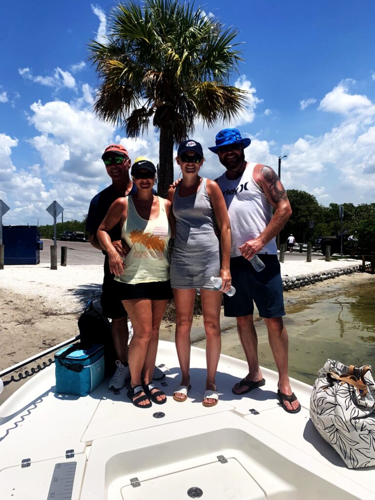 A group of five aboard the boat on a clear day